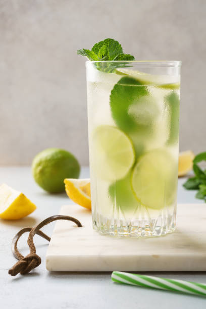 istock Cold lemonade with fresh lemon, lime and mint in a glass. 1157112425
