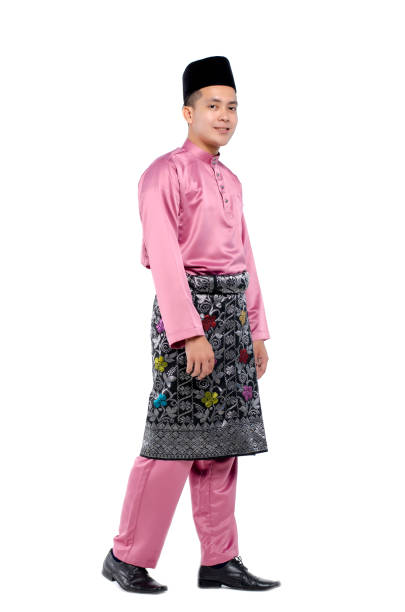 istock Man In Traditional Clothing Walking Against White Background 1157112740