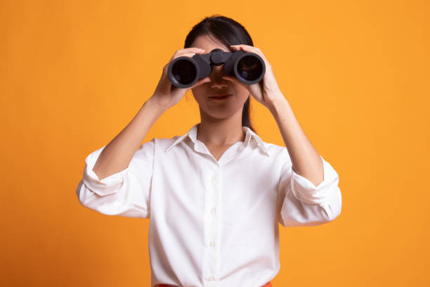 istock Young Asian woman with binoculars. 1157116260