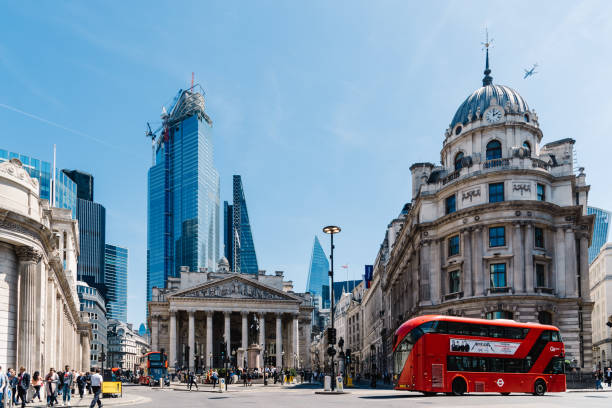 The Royal Exchange and The Bank of England in London London, UK - May 14, 2019: The Royal Exchange and The Bank of England against skyscrapers in the City of London a sunny day bank of england stock pictures, royalty-free photos & images