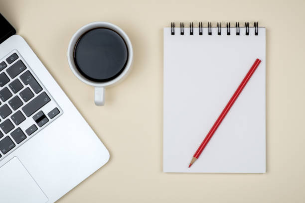 istock Minimal workplace with laptop and blank notepad on colored background. Top view. Flat lay 1157117152