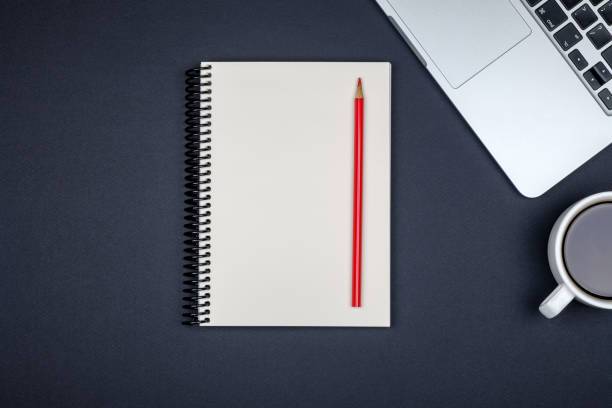 istock Minimal workplace with laptop and blank notepad on colored background. Top view. Flat lay 1157117168