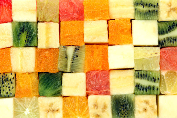 istock fresh fruits cut in cubes stacked together on white background 1157117362