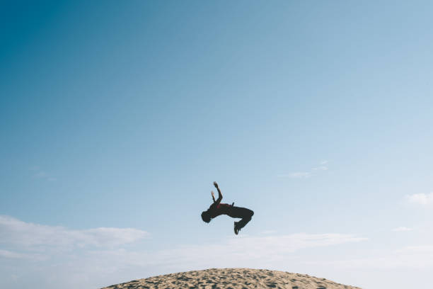 istock Low Angle View Of Man Jumping Against Sky 1157117636