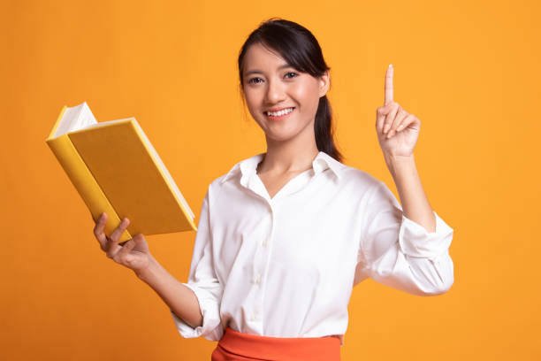 istock Young Asian woman with a book have an idea. 1157121221