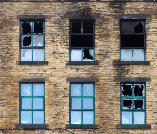 istock broken windows in a large burned out old industrial building after a fire 1157121603