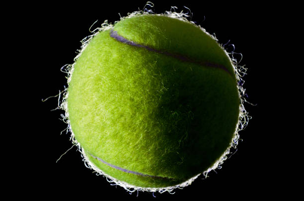 istock Tennis ball on black background 1157122695