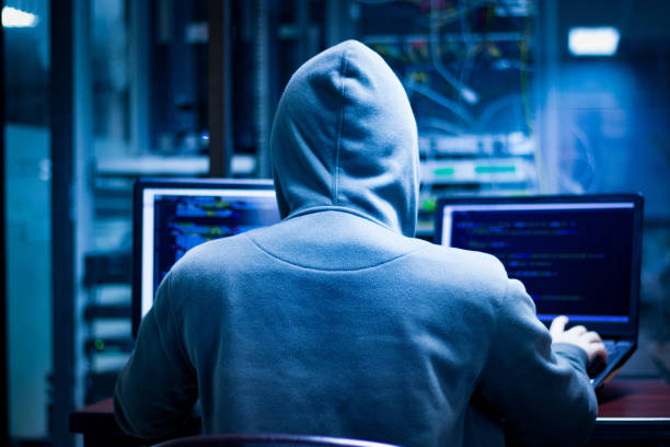 istock Hackers often work in low-light rooms to cover their faces. And obscure action. 1157124075
