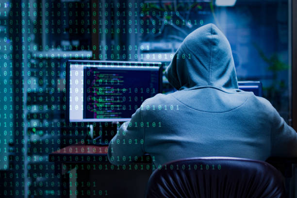 A hacker or cracker tries to hack a security system to steal or destroy critical information. Or a ransom of important information of the company. Hackers using laptop computers to penetrate security systems to steal big data from the server room computer crime stock pictures, royalty-free photos & images