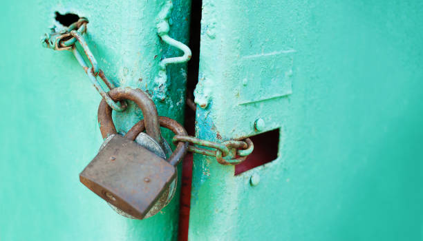 istock Metal door with Two old rusty padlock. Copy space. Security and protection conception 1157124973