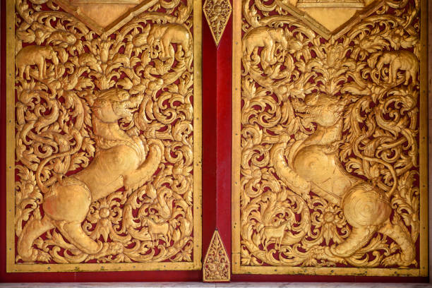Engraved dragon on wooden window panel painted in gold color