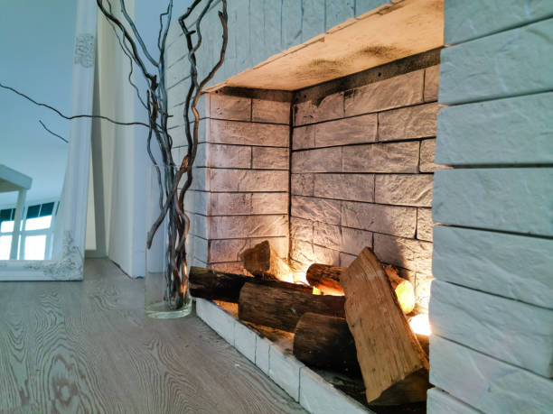 istock white fireplace in light room with Christmas decoration 1157126084