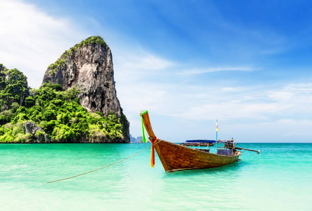 Thai traditional wooden longtail boat. Thai traditional wooden longtail boat and beautiful sand Railay Beach in Krabi province. Ao Nang, Thailand. koh poda stock pictures, royalty-free photos & images