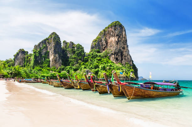Thai traditional wooden longtail boats and beautiful sand beach. Thai traditional wooden longtail boats and beautiful sand Railay Beach in Krabi province. Ao Nang, Thailand. koh poda stock pictures, royalty-free photos & images