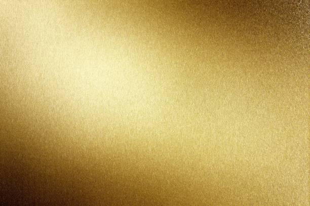 istock Light shining on brushed gold metal plate, abstract texture background 1157128003