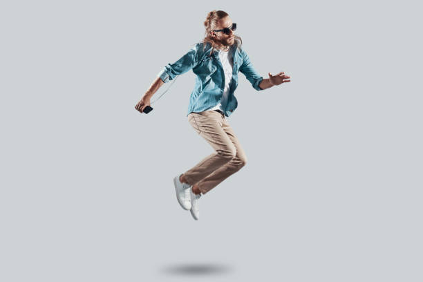 istock Fly! Full length of handsome young man hovering against grey background 1157128146