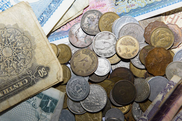 istock old paper banknote and metal coins 1157129299