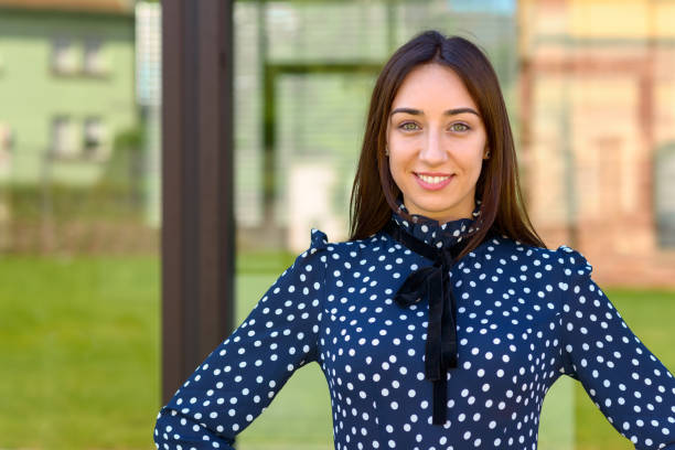 istock Confident young woman with hands on her hips 1157129452