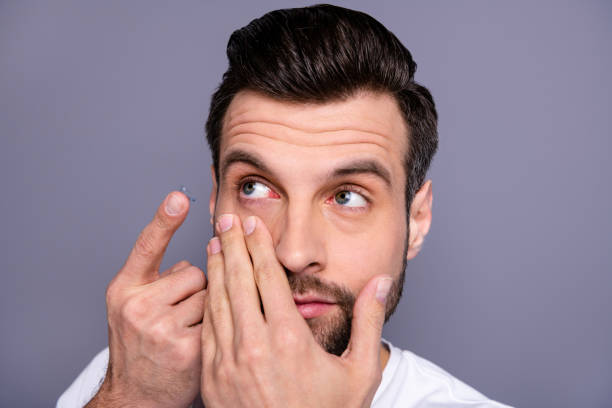 istock Close up photo charming youth have eye sight problem need correction hyperopia look want good eye condition stubble bristle wear white clothing isolated grey background 1157129814
