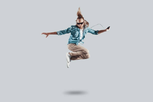 istock So cool! Full length of handsome young man hovering against grey background 1157130739