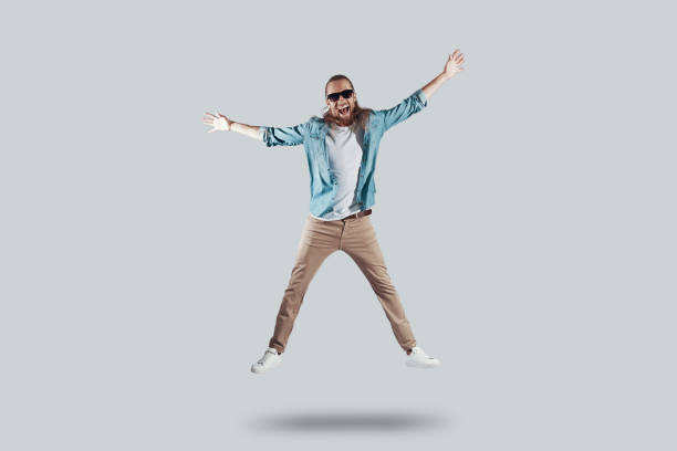 istock Totally free. Full length of handsome young man keeping arms outstretched while hovering against grey background 1157131733