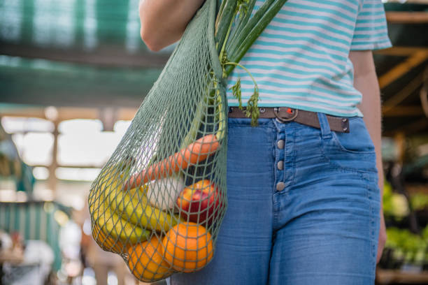 istock Fruits and Vegetables in a cotton mesh reusable bag, Zero Waste Outdoors Shopping 1157131948