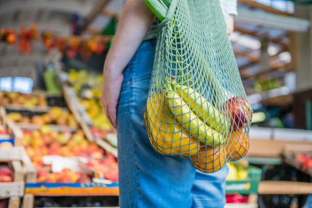istock Fruits and Vegetables in a cotton mesh reusable bag, Zero Waste Outdoors Shopping 1157131977