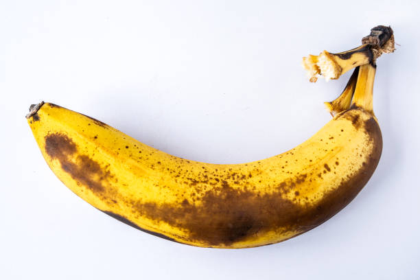 Last banana of a bunch nearly overripe Last banana of a bunch nearly overripe - isolated bruised fruit stock pictures, royalty-free photos & images