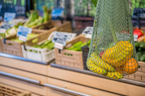 Fruits and Vegetables in a cotton mesh reusable bag, Zero Waste Shopping Close Up.