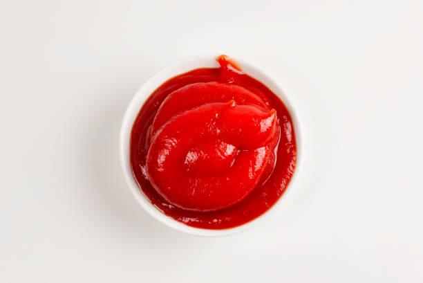 istock Ketchup in white plate on white background. 1157133868