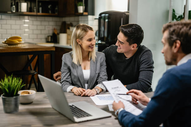 istock Happy couple communicating while having a meeting with financial advisor at home. 1157134928
