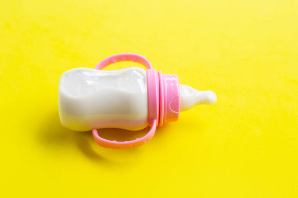 istock Milk for baby on yellow background. 1157135032