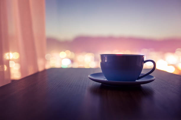 Cup of coffee on table at night