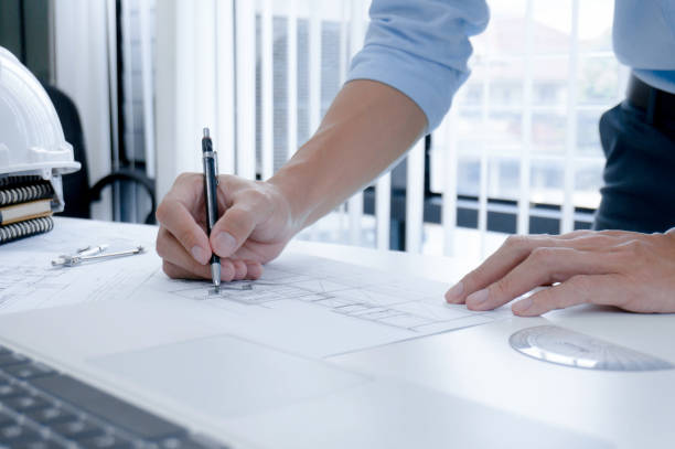 istock Colleagues interior designer Corporate Achievement Planning Design on blueprint Teamwork Concept with compasse. 1157136182