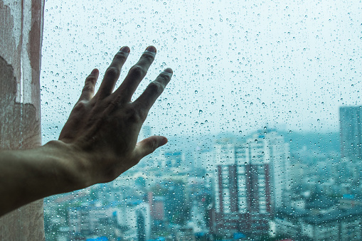 touching rainy window