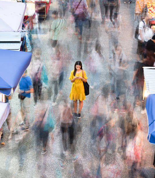 istock Woman using phone, motioned blurred market 1157136608