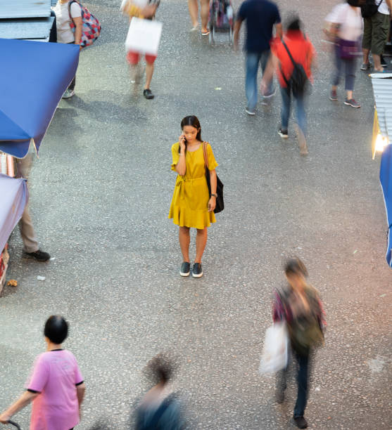 istock Woman using phone, motioned blurred market 1157136614