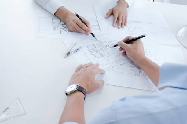istock Colleagues interior designer Corporate Achievement Planning Design on blueprint Teamwork Concept with compasse. 1157136683