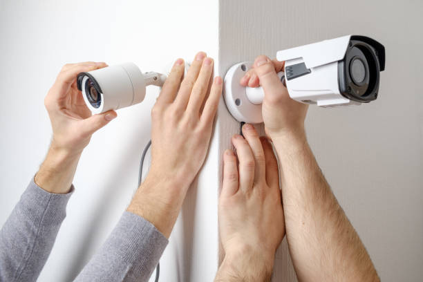 istock CCTV Concept. Workers installing video surveillance cameras on walls 1157138999