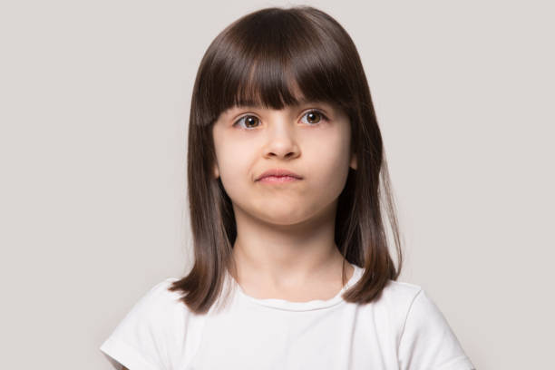 istock Upset little girl isolated on grey studio background 1157139755