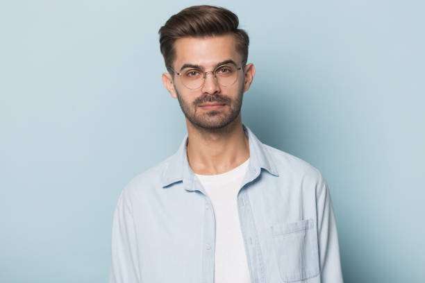 istock Serious guy wearing glasses posing isolated on blue studio background 1157139796