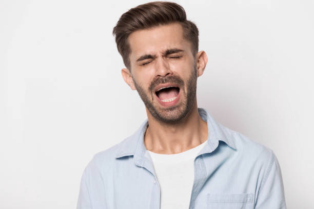 istock Hysterical guy closed eyes screaming or whines isolated on white 1157139832