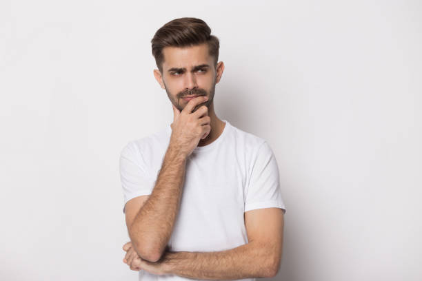 istock Pensive guy isolated on white background touch chin thinking 1157139836