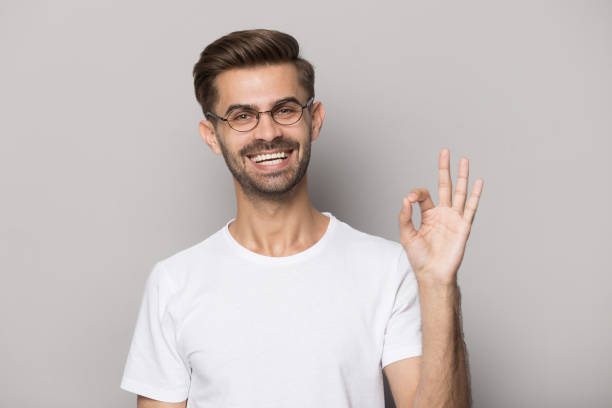istock Happy guy gesturing ok sign smiling looking at camera 1157139839