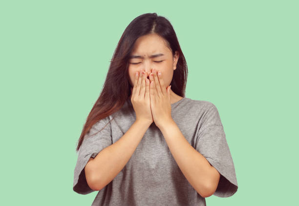 istock young woman in action when get a bad smell. 1157141241