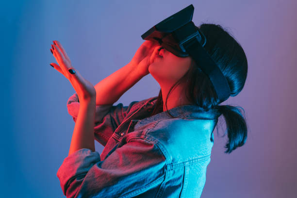 istock Young woman enjoying virtual reality simulator 1157142354