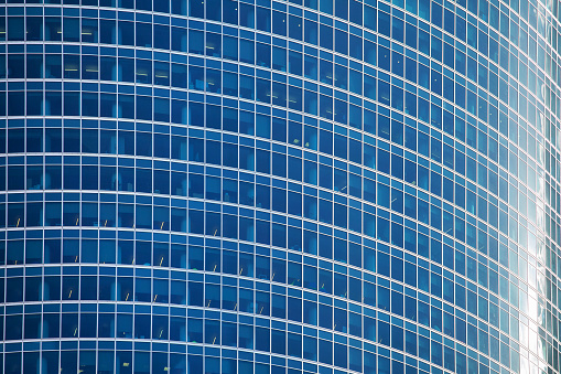 Blue glass skyscraper wall surface close up, modern business center view, financial city district, commercial downtown design, building facade, art geometric pattern, graphic lines texture, copy space