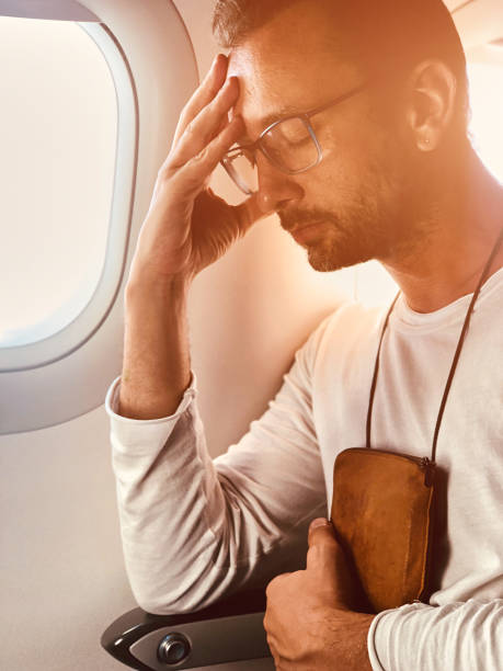 istock Airplane passenger with a neck bag for safe carrying money and documents. 1157142414