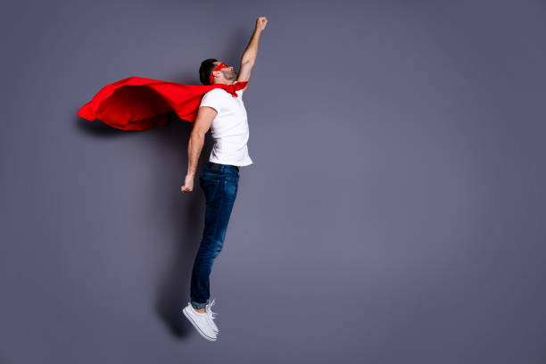 A man with a cape, arm raised high, symbolizing victory or leadership. 3D rendering, conceptual image. Isolated on white background.