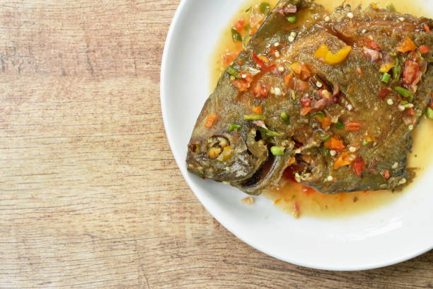 istock deep fried white pomfret dressing spicy sauce 1157143571
